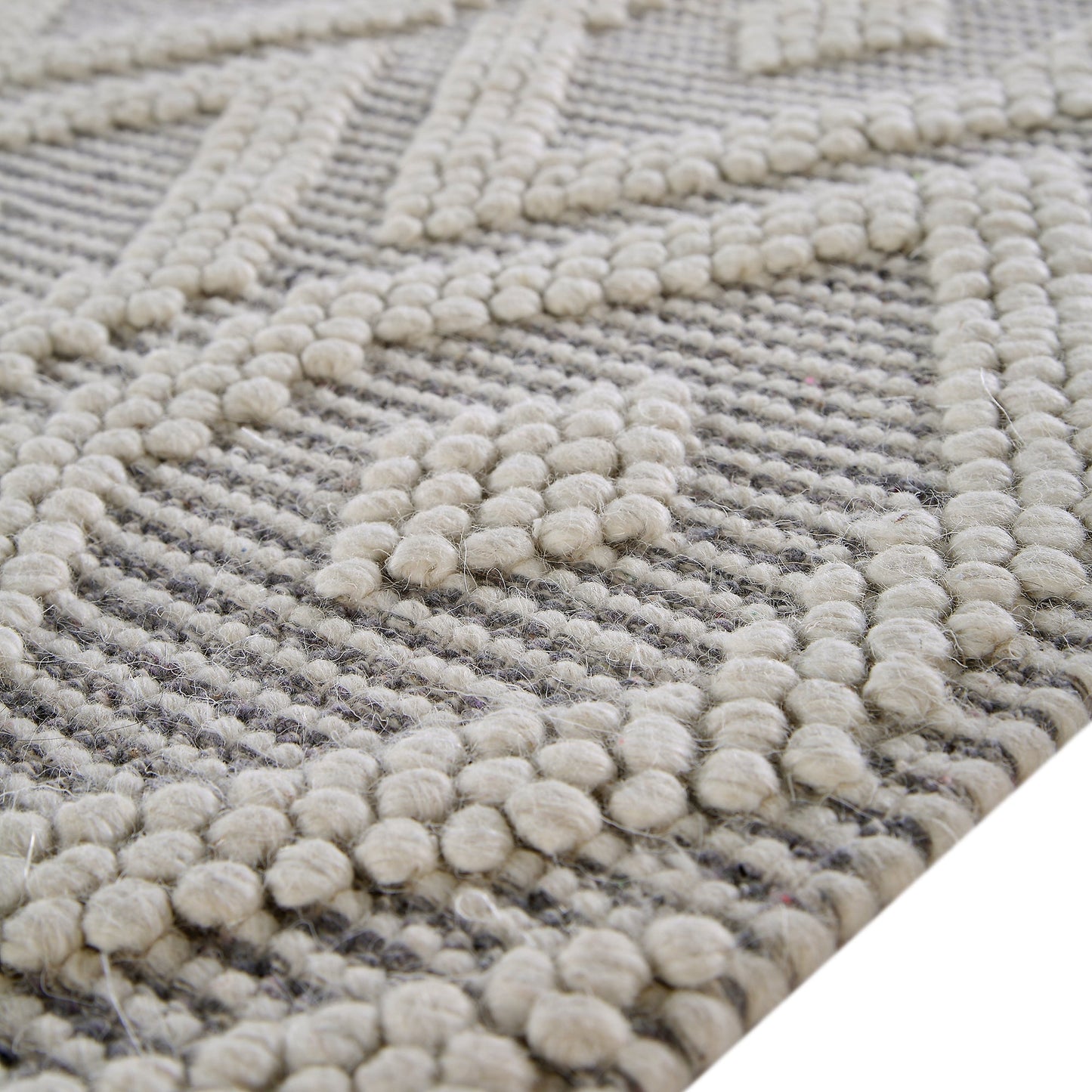 Tapis en laine tissé à la main Avanti gris clair et crème à pompons en losanges