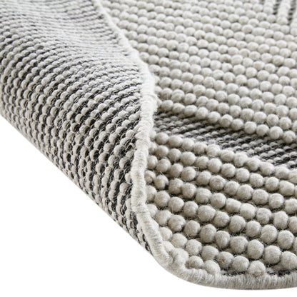 Tapis rond en laine tissé à la main Avanti, motif sel et poivre, à pompons et diamants