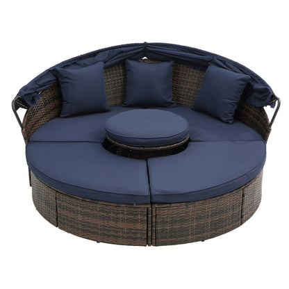 Lit de jour rond en rotin d'extérieur avec auvent et table basse relevable, canapé-lit bleu marine à assise profonde avec oreillers et coussins lavables