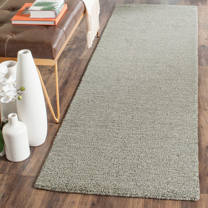 Tapis moderne en laine SAFAVIEH fait main, bordure en palmier de l'Himalaya